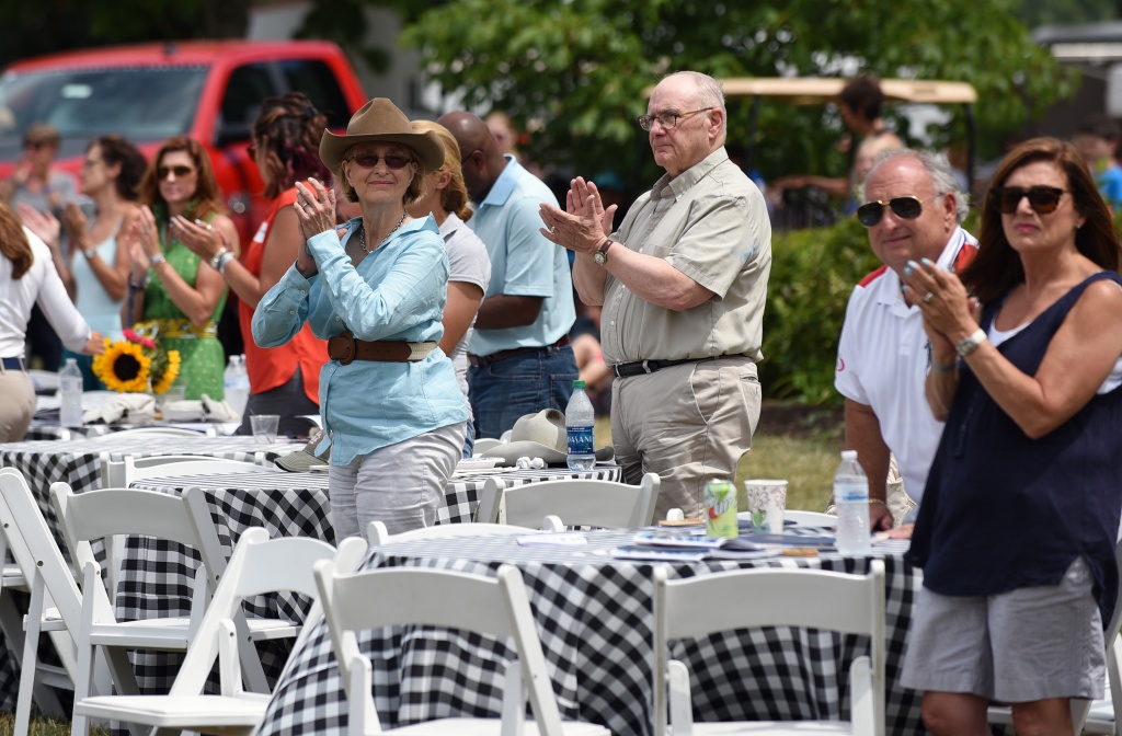 CHJC2016_spec_3671: Spectators applaud a horse and rider competing in the 2016 Chagrin Hunter Jumper Classic at the Cleveland MetroParks Polo Fields in Moreland Hills, Ohio, Sunday, July 17, 2016. (Photo by Peggy Turbett for the Chagrin Hunter Jumper Classic)