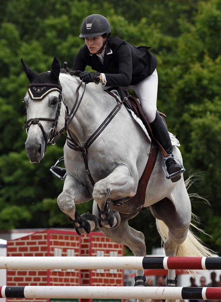 Megan Bash of Hunting Valley, Ohio, approaches aspread fence on Pourkoipa Fontaine, a 13-year-old Selle Francais gelding, during the jump off round of the Chagrin Hunter Jumper Classic Grand Prix at the Cleveland MetroParks Polo Fields in Moreland Hills, Ohio, Sunday, July 17, 2016. Bash finished with a combined time of 85.197 for the second place red ribbon in the 51st Cleveland Grand Prix 2016. (Photo by Peggy Turbett for the Chagrin Hunter Jumper Classic)