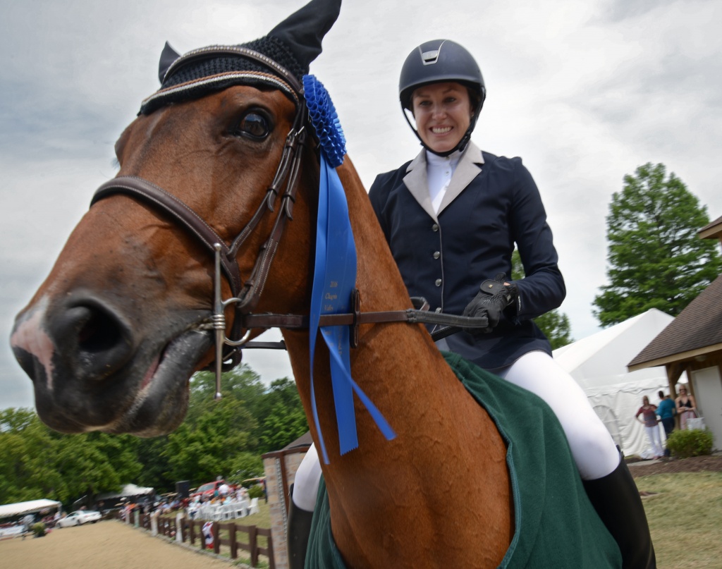 Constara, a 12-year-old Warmblood, sports the Blue Ribbon won by first place rider Whitney Lyon, 32, of Marengo, Ill., at the Chagrin Hunter Jumper Classic Grand Prix at the Cleveland MetroParks Polo Fields in Moreland Hills, Ohio, Sunday, July 17, 2016. Lyon, entering her first Grand Prix competition, won the 51st Cleveland Grand Prix with a total time of 84.967. (Photo by Peggy Turbett /Chagrin Hunter Jumper Classic )